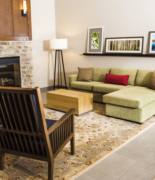 interior image of a sitting area in the lobby of the country inn and suites in winchester virginia showing a fireplace, couch and chairs